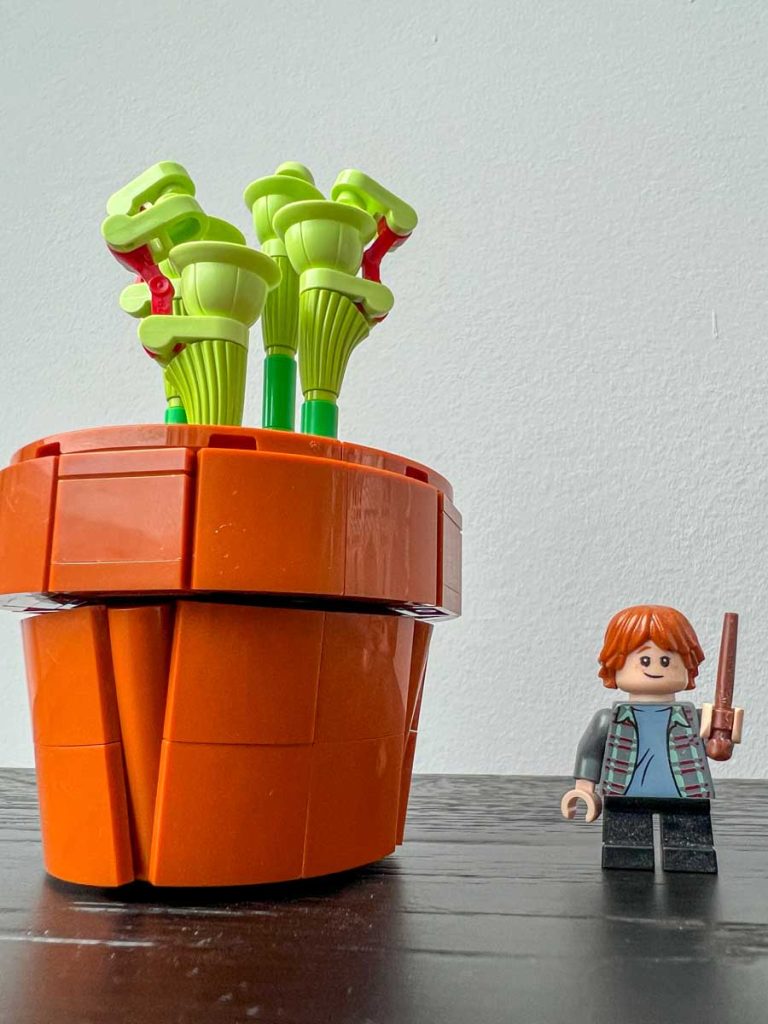 A carnivorous pitcher plant made of Lego bricks from the Lego Tiny Plants set (10329). Ron Weasley Granger minifigure for scale.