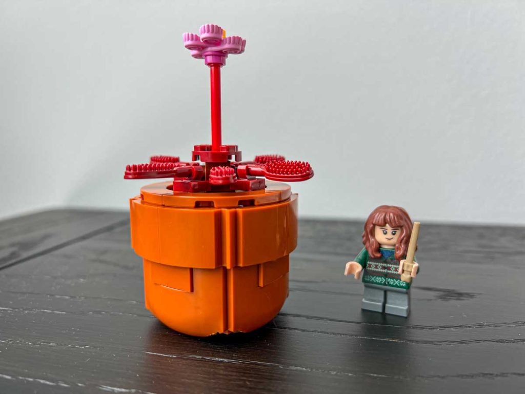 A carnivorous sundew Lego plant from the Lego Tiny Plants set (10329). Hermione Granger minifigure for scale.
